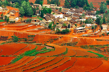 Image showing Village on red field