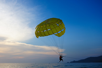 Image showing Man parasailing at sunset