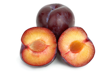 Image showing Violet plums: whole and two halves