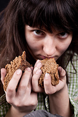 Image showing beggar woman with a piece of bread in her hands