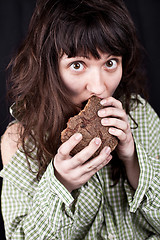 Image showing beggar woman eating bread