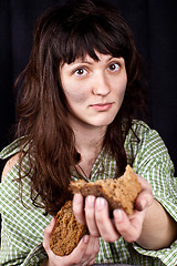 Image showing beggar woman with a piece of bread in her hands