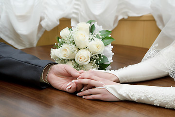 Image showing hands of the bride and groom