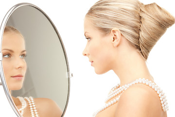 Image showing beautiful woman with pearl beads and mirror