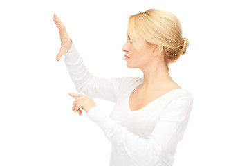 Image showing businesswoman working with something imaginary