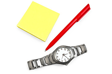 Image showing Yellow paper with a red pen, wristwatch