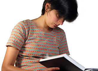 Image showing Girl looking in a notebook