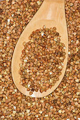 Image showing Wooden spoon with uncooked buckwheat