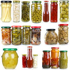 Image showing Set of different berries, mushrooms and vegetables conserved in glass jars