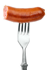 Image showing Half eaten sausage on fork