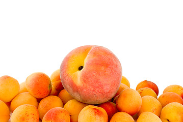 Image showing Red peach over the pile of apricots