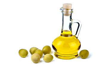 Image showing Small decanter with olive oil and some olives near