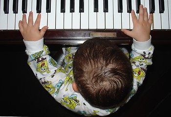 Image showing Infant playing the piano