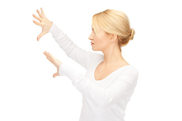 Image showing businesswoman working with something imaginary