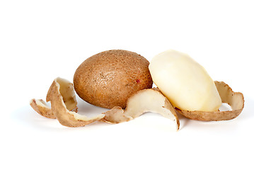 Image showing Whole and peeled potatoes and some peel