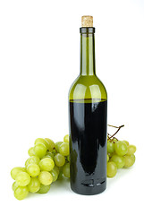 Image showing Bottle with red wine and green grapes near