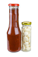 Image showing Bottles with tomato ketchup and marinated garlic