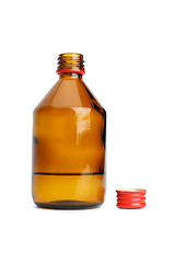 Image showing Bottle with liquid and cap near