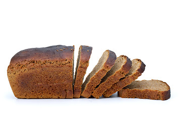 Image showing Chunk of rye bread with anise and some slices