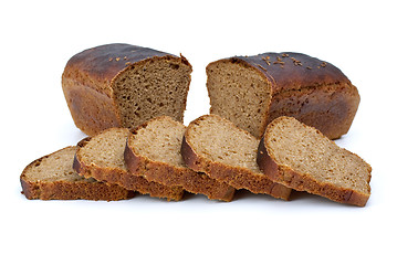 Image showing Two chunks of rye bread with anise and some slices