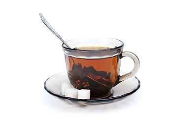 Image showing Teacup with black tea, teaspoon, dish and some sugar pieces