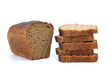 Image showing Chunk of rye bread with anise and some slices