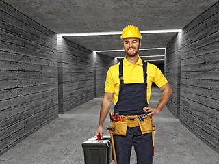 Image showing manual worker in concrete tunnel background