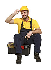 Image showing handyman sit on his toolbox