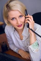 Image showing Young businesswoman talk on the phone in the office 