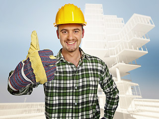 Image showing smiling handyman and building background