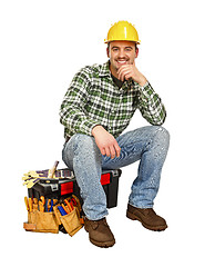 Image showing young handyman sit on toolbox