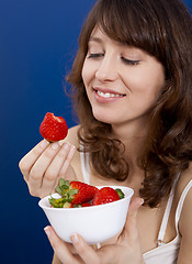 Image showing Eating strawberries