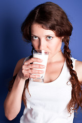 Image showing young woman drinking a milk 
