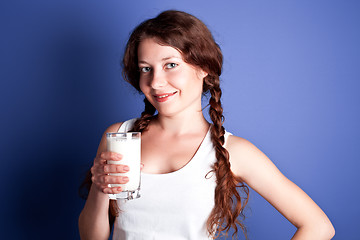 Image showing  woman enjoying a glass of milk 