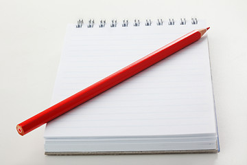 Image showing The notepad and red pencil