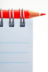 Image showing The notepad and red pencil