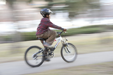 Image showing Young boy riding a bike