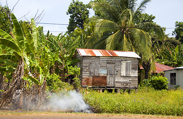 Image showing garbage burning jungle clapboard house Corn Island Nicaragua