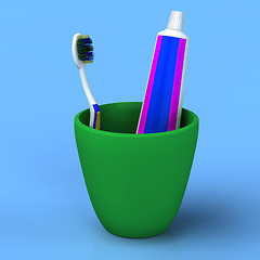 Image showing Toothbrush and gel toothpaste in  green cup