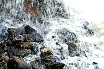 Image showing Scenic waterfall  cascading over rocks