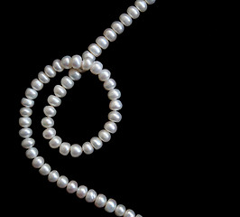 Image showing White pearls on the black silk 