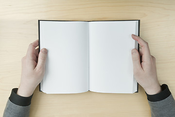Image showing Man reading a blank book