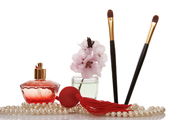 Image showing Pearls beads, perfume, two cosmetics brush