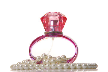 Image showing Perfume in a glass bottle and pearl beeds