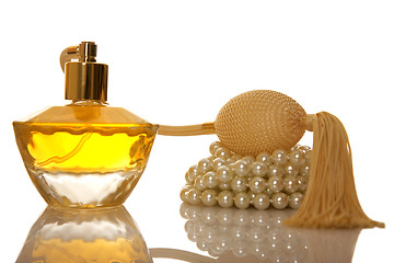 Image showing Perfume in a glass bottle and pearl beeds