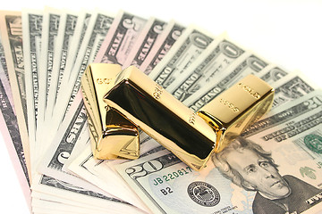 Image showing Gold bullion on dollar bills