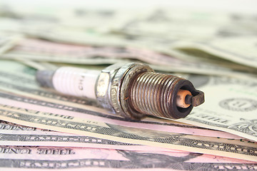 Image showing spark plug on dollar bills