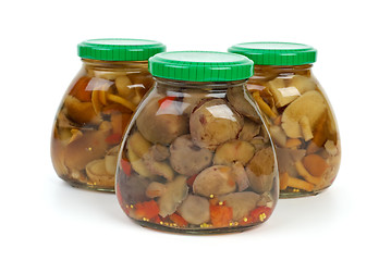 Image showing Glass jars with marinated mushrooms