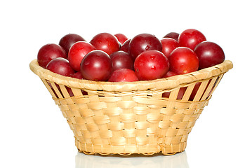 Image showing Wicker basket with cherry plums