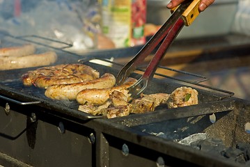 Image showing Sausages and meat on the grill